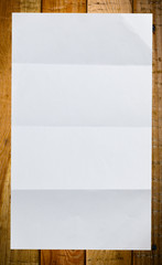 Sheet of white paper on wood
