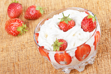 Vase of strawberries with cream