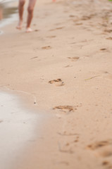 Running footprints on beach