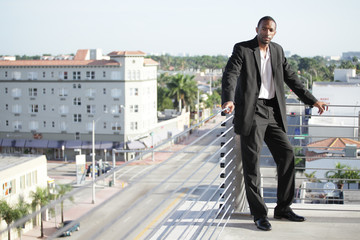 Businessman posing by the ledge