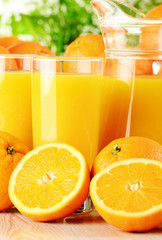 Composition with two glasses of orange juice and fruits