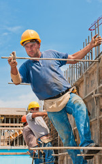Construction workers installing formwork frames - 35283377