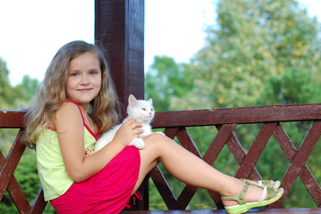 The little girl with a white kitten