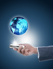 businessman holding mobile phone with globe