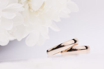 White flowers and  wedding rings