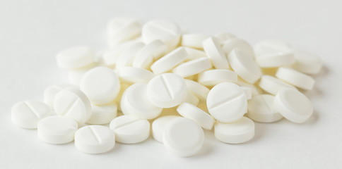 Fototapeta na wymiar white pills on white background