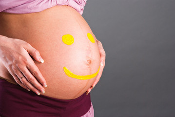 Yellow smilies on the abdomen of pregnant women