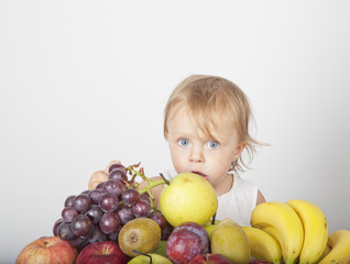 Fototapeta na wymiar blonde girl grabbing fruit