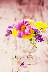 Spring flowers in a wineglass