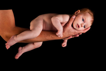 Obraz premium Infant girl on fathers arms isolated on black