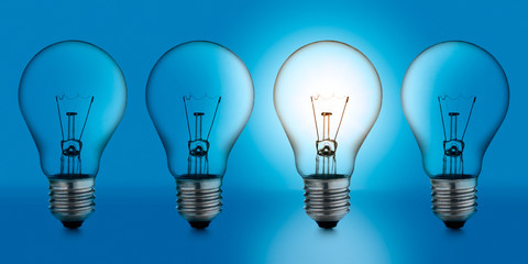 Naklejka premium light bulb, on blue background