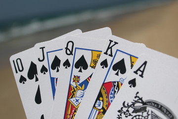 Poker hand - Royal Flush, with beach background
