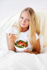Obraz na płótnie Canvas Closeup portrait of pretty caucasian woman having a healthy diet