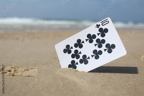 Playing Card The 10 Club In Sand Beach Background Playing Card The 10 Club In Sand Beach Background