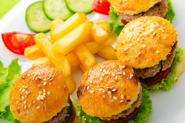 Plate with tasty mini burgers