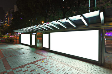Blank billboard on bus stop at night