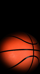 Basketball ball with dark edges on black background