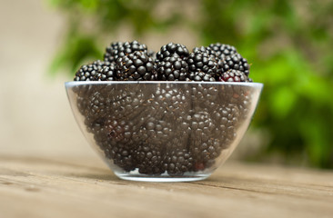 blackberries in bowl on wooden table