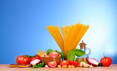 spaghetti with garlic, onion, spices  and basil on a yellow back