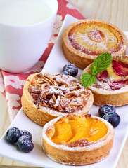 4 different fruit  cakes.