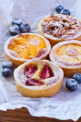 4 different fruit  cakes.