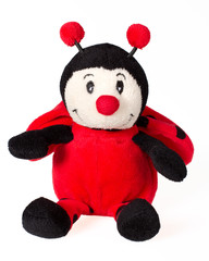 Ladybug smiling sitting over white background. Plush toy isolate