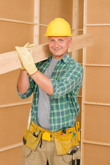 Handyman carpenter mature carry wooden beam