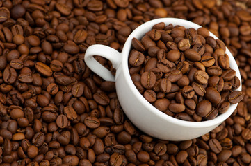 White cup with coffee grains