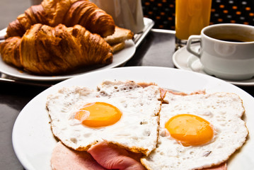 Breakfast with coffee and croissants on table