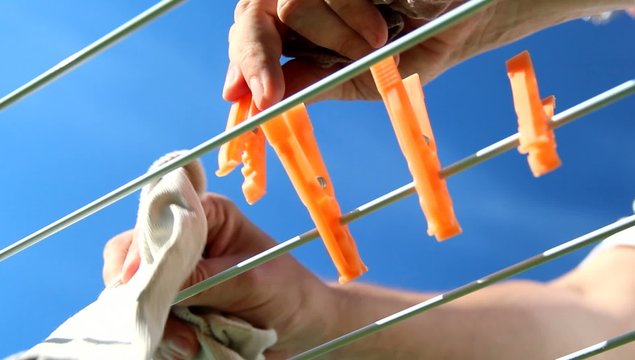 Male - Picking Laundry from the Clothesline