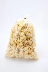 Fotobehang bag of popcorn, a plastic bag of popcorn. © akeeris