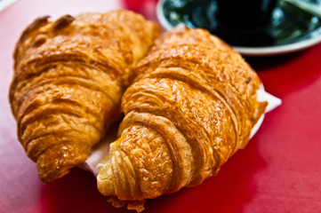 Breakfast with coffee and croissants on table