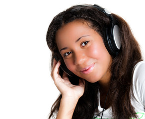 Smiling teenage girl with headphones, listening to music
