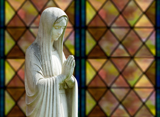 Isolated statue of Mary against window