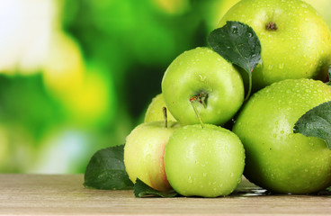 Fresh organic apples on wooden table isolated on white