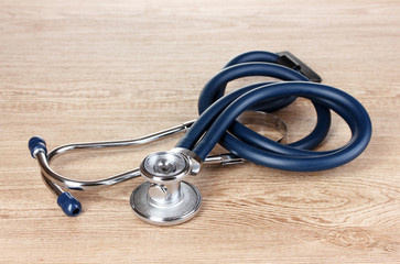 Medical stethoscope on wooden background