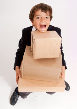 Happy schoolboy carrying boxes
