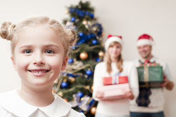 Merry Christmas - little girl with family at Christmas time