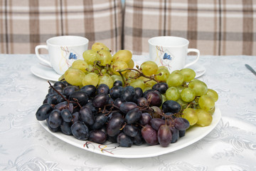 grapes and cups on the table