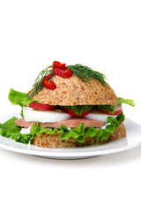 Sandwich of corn bread with lettuce and ham.