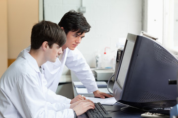 Scientists working with a monitor