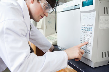 Naklejka na ściany i meble Science student using a laboratory chamber furnace in a laborato