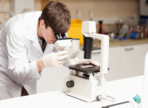 Science student looking in a microscope