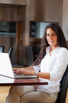 Portrait of a young woman using a laptop