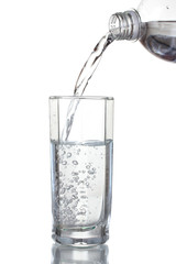 Pouring water on glass isolated on white