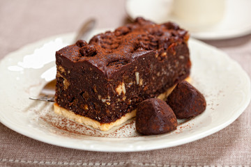 Dark chocolate cake and chocolate truffles on a plate