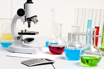 flasks, microscope, calculator, workplace