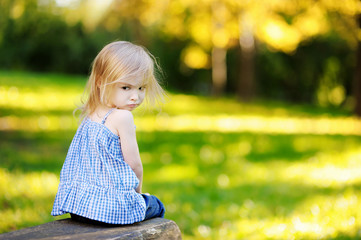 Angry little girl portrait outdoors © MNStudio