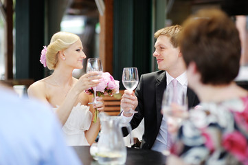Bride and groom drinking champagne at their wedding