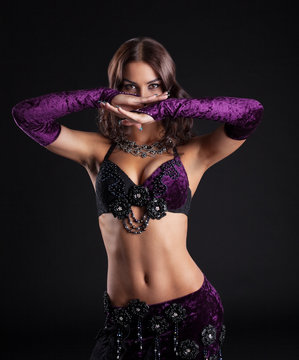 Attractive brunette girl posing in arabic dance